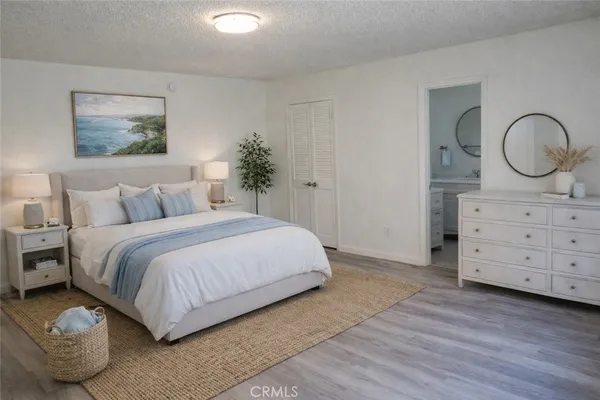 a bedroom with a bed and a dresser