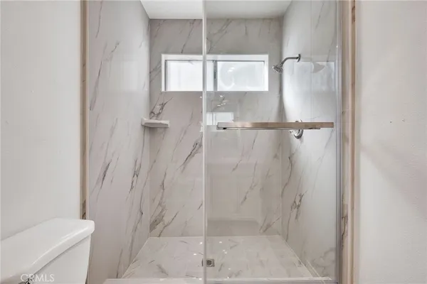 a bathroom with a shower and toilet