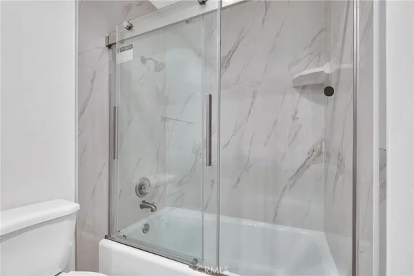 a bathroom with a bathtub and a toilet