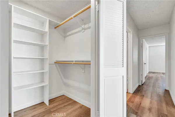 a view of a room with wooden floor