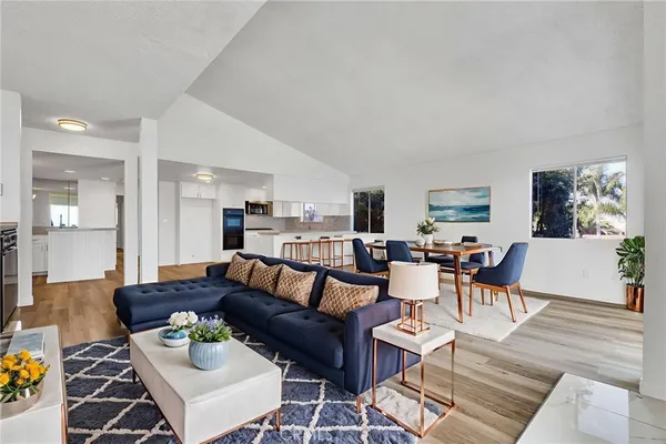a living room with furniture and kitchen view