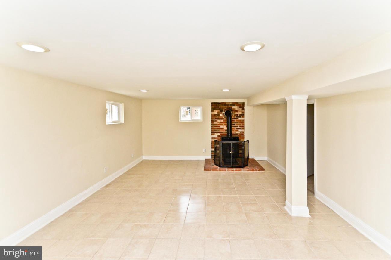 14302 Duckett Road Brandywine, MD 20613 - Photo 17 of 25 Basement Rec w/woodstove