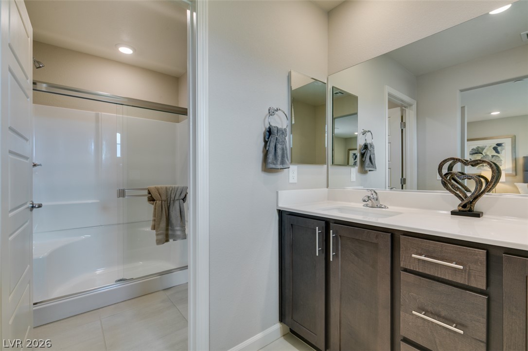 653 Pickled Pepper Place Henderson, NV 89011 - Photo 29 of 35 A contemporary vanity with crisp white countertops and a spacious shower provides a refreshing start to any day.