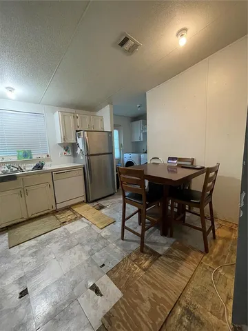 a kitchen with a table and chairs in it