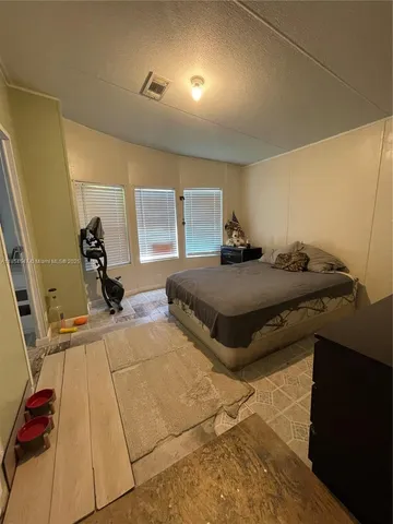 a bedroom with a bed and a walk in closet