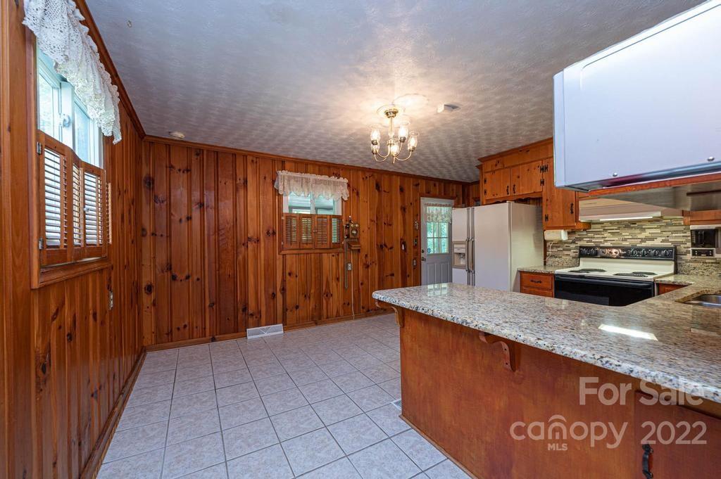 4254 Hartland Road Lenoir, NC 28645 - Photo 24 of 47 a view of a kitchen with a sink and a large mirror