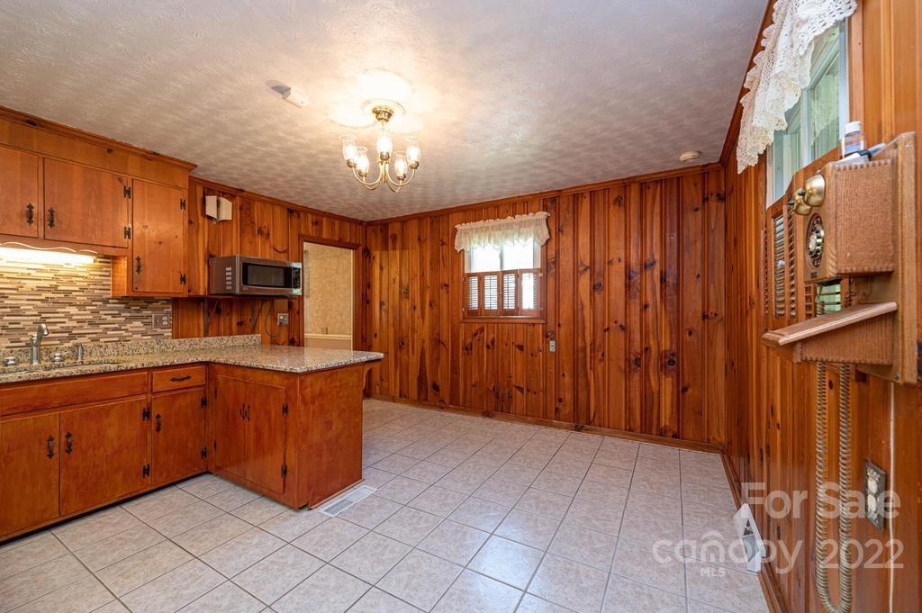 4254 Hartland Road Lenoir, NC 28645 - Photo 27 of 47 a large kitchen with stainless steel appliances granite countertop a refrigerator and a sink