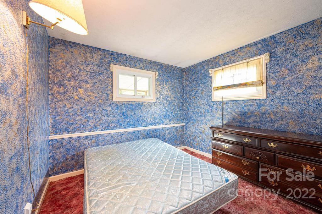 4254 Hartland Road Lenoir, NC 28645 - Photo 32 of 47 a bathroom with a bathtub and a window