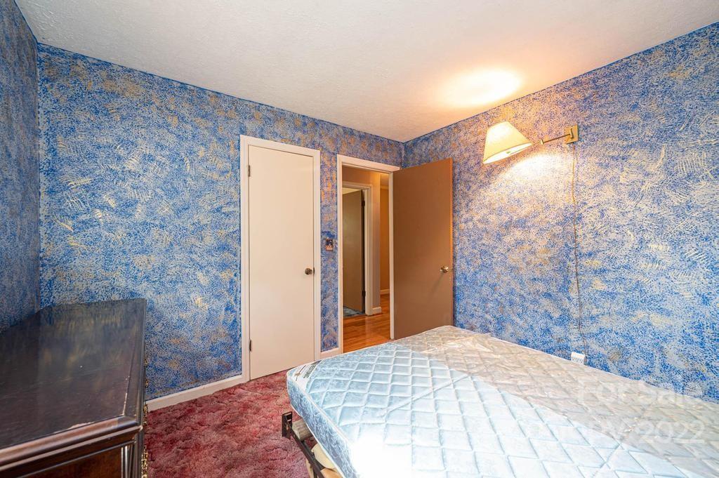 4254 Hartland Road Lenoir, NC 28645 - Photo 34 of 47 a bedroom with a bed and a mirror