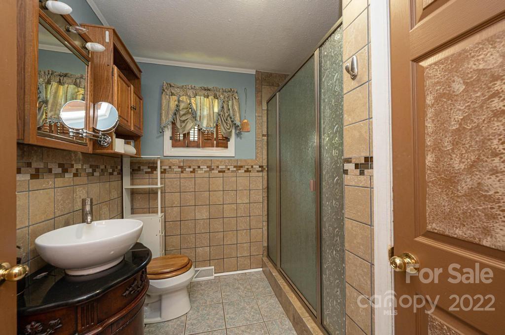 4254 Hartland Road Lenoir, NC 28645 - Photo 39 of 47 a bathroom with a toilet sink and shower