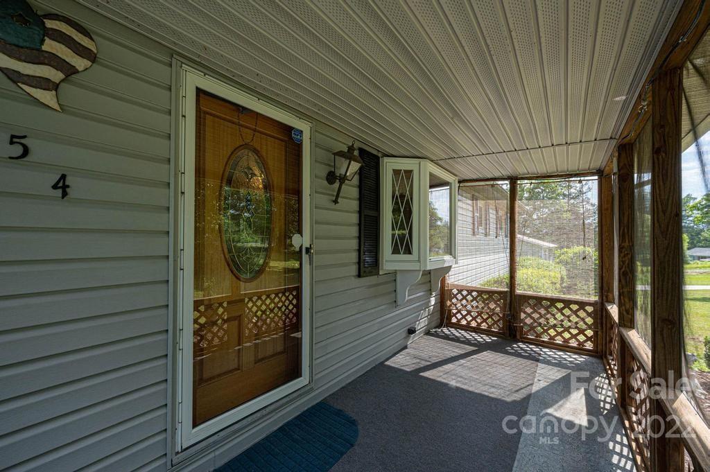 4254 Hartland Road Lenoir, NC 28645 - Photo 6 of 47 a view of a porch with a table and chairs