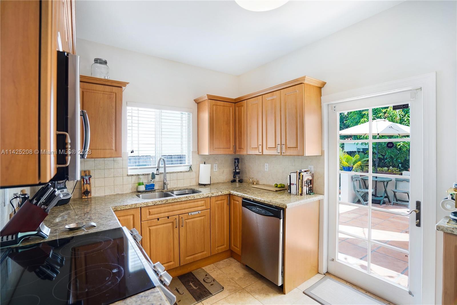 2235 Southwest 11th Terrace Miami, FL 33135 - Photo 23 of 43 a kitchen with a sink a counter top space and cabinets