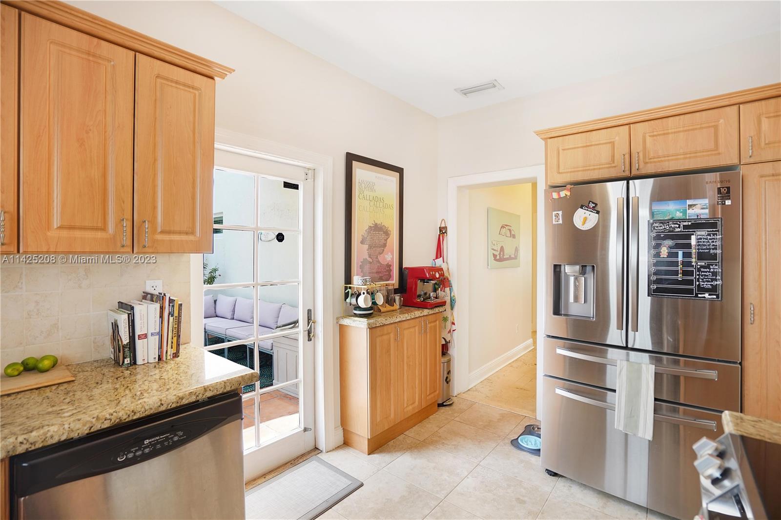 2235 Southwest 11th Terrace Miami, FL 33135 - Photo 24 of 43 a kitchen with stainless steel appliances granite countertop a refrigerator and a stove top oven