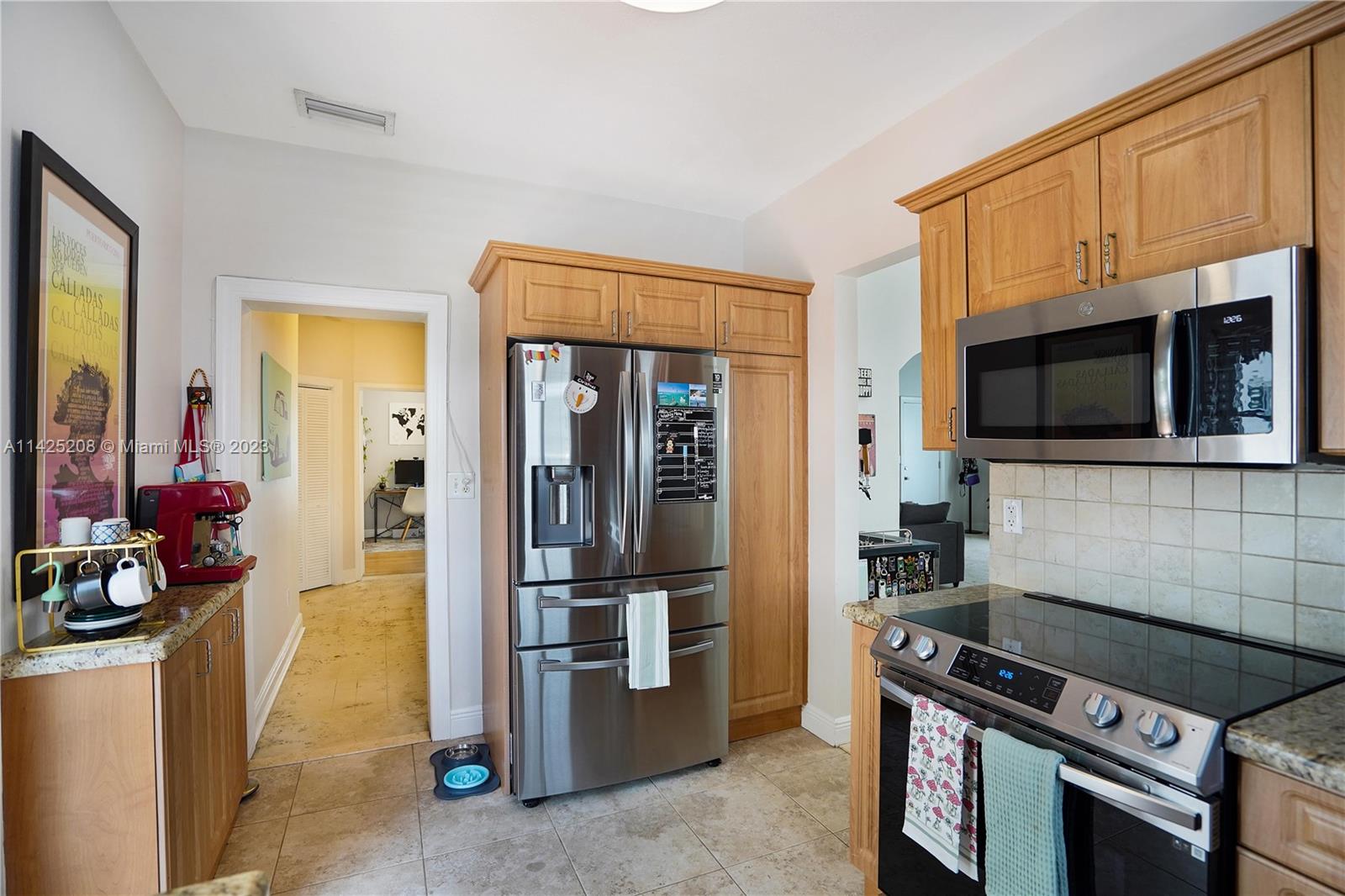 2235 Southwest 11th Terrace Miami, FL 33135 - Photo 25 of 43 a kitchen with a stove and a microwave