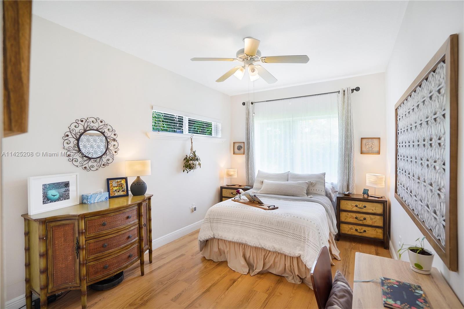 2235 Southwest 11th Terrace Miami, FL 33135 - Photo 30 of 43 a bedroom with a bed and wooden floor