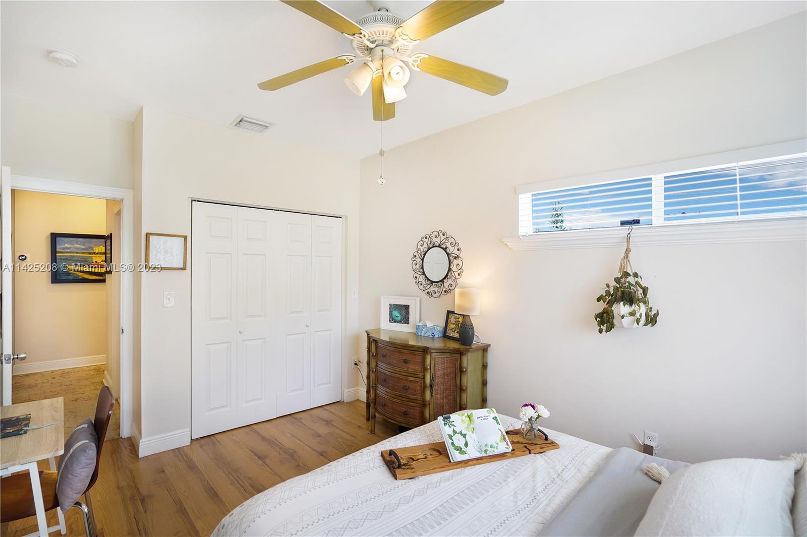 2235 Southwest 11th Terrace Miami, FL 33135 - Photo 31 of 43 a bedroom with a bed and a chandelier