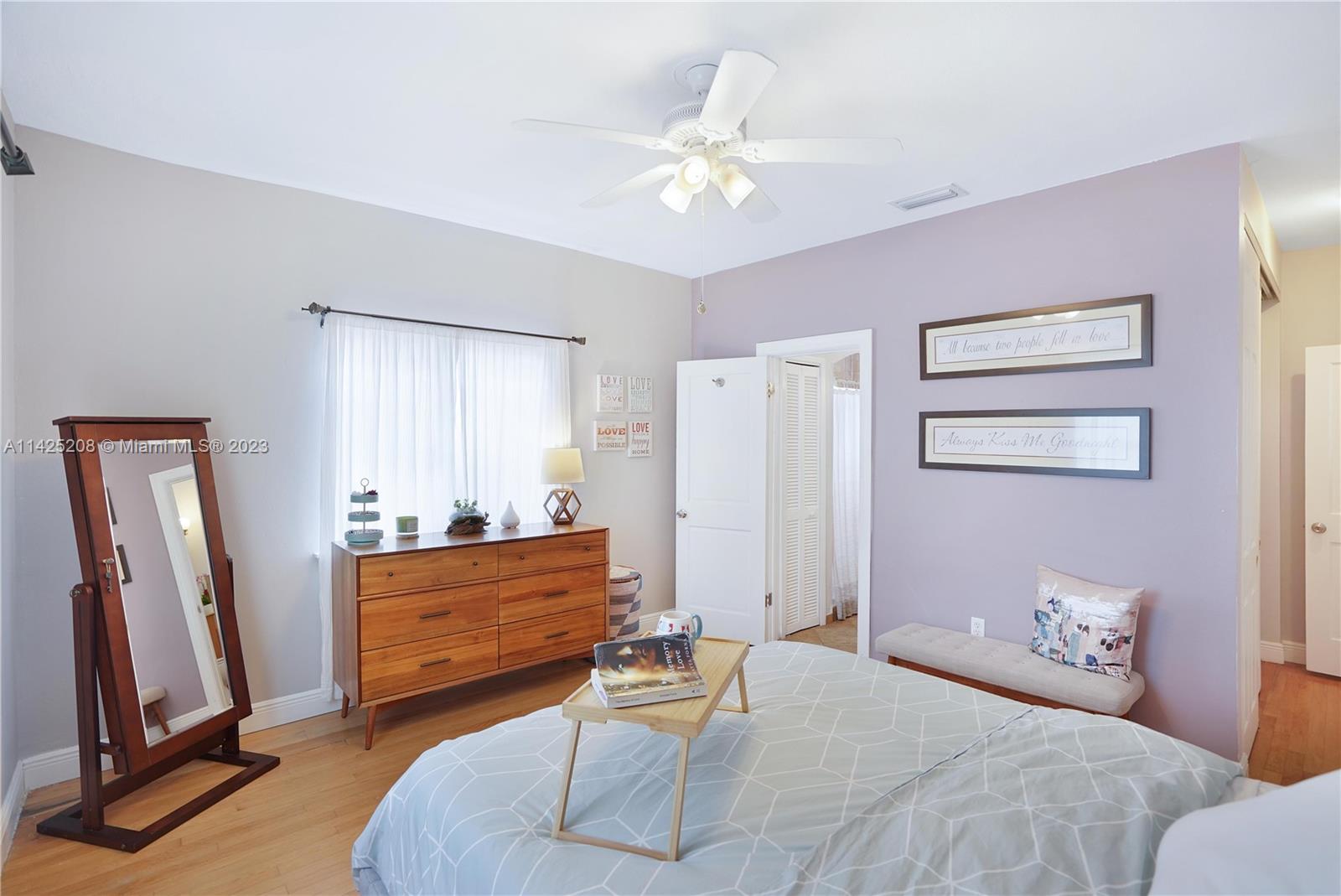 2235 Southwest 11th Terrace Miami, FL 33135 - Photo 33 of 43 a bedroom with a bed and a chandelier