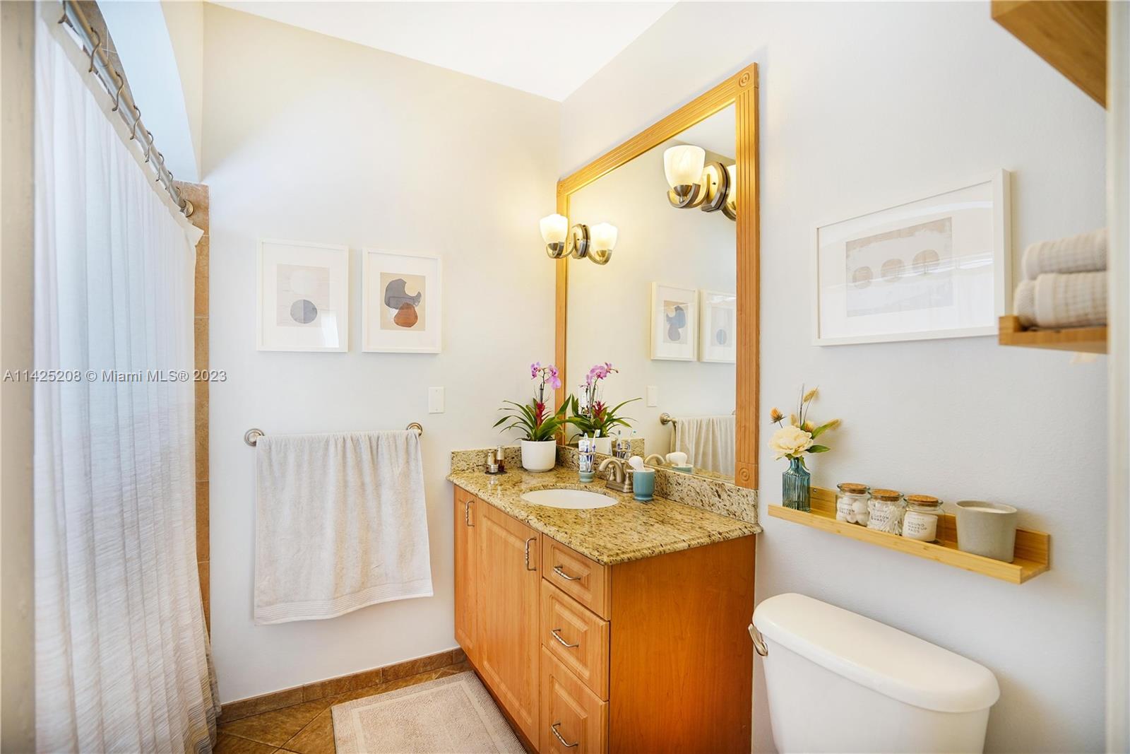 2235 Southwest 11th Terrace Miami, FL 33135 - Photo 35 of 43 a bathroom with a granite countertop sink and a mirror