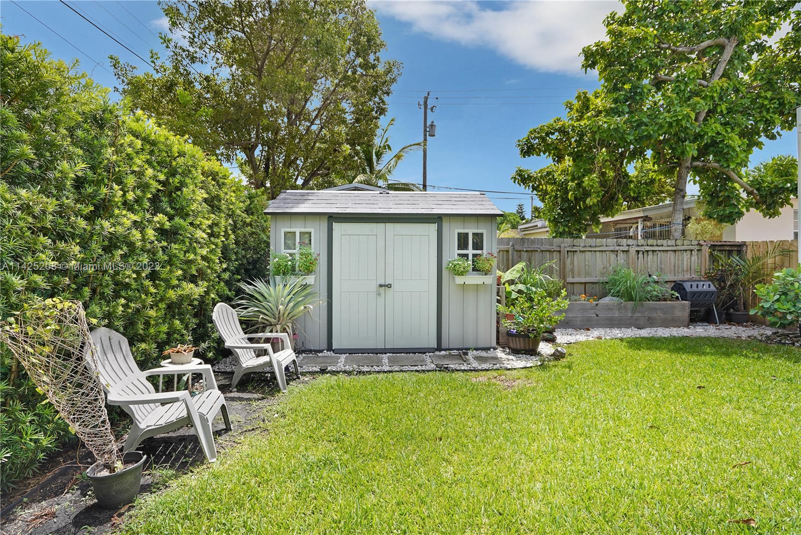 2235 Southwest 11th Terrace Miami, FL 33135 - Photo 42 of 43 a view of a chair and table in backyard of the house