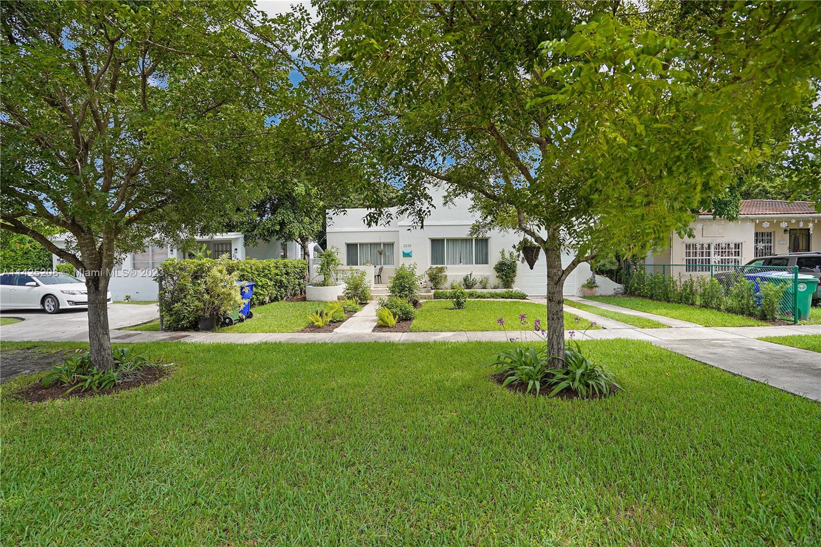 2235 Southwest 11th Terrace Miami, FL 33135 - Photo 8 of 43 a front view of a house with a yard