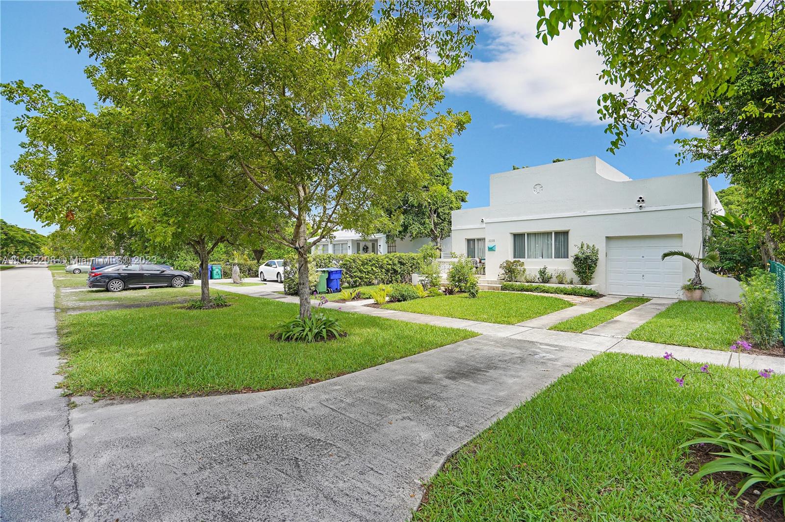 2235 Southwest 11th Terrace Miami, FL 33135 - Photo 9 of 43 a view of a house with a big yard potted plants and large tree