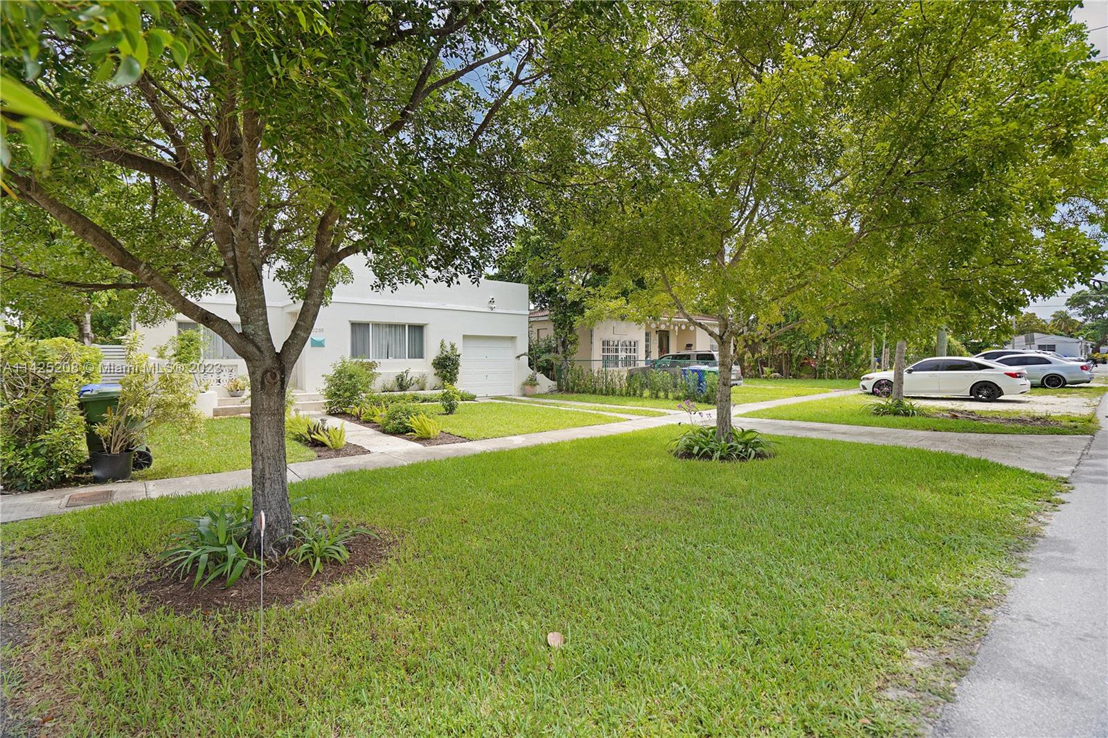 2235 Southwest 11th Terrace Miami, FL 33135 - Photo 10 of 43 a view of a house with a big yard and palm trees