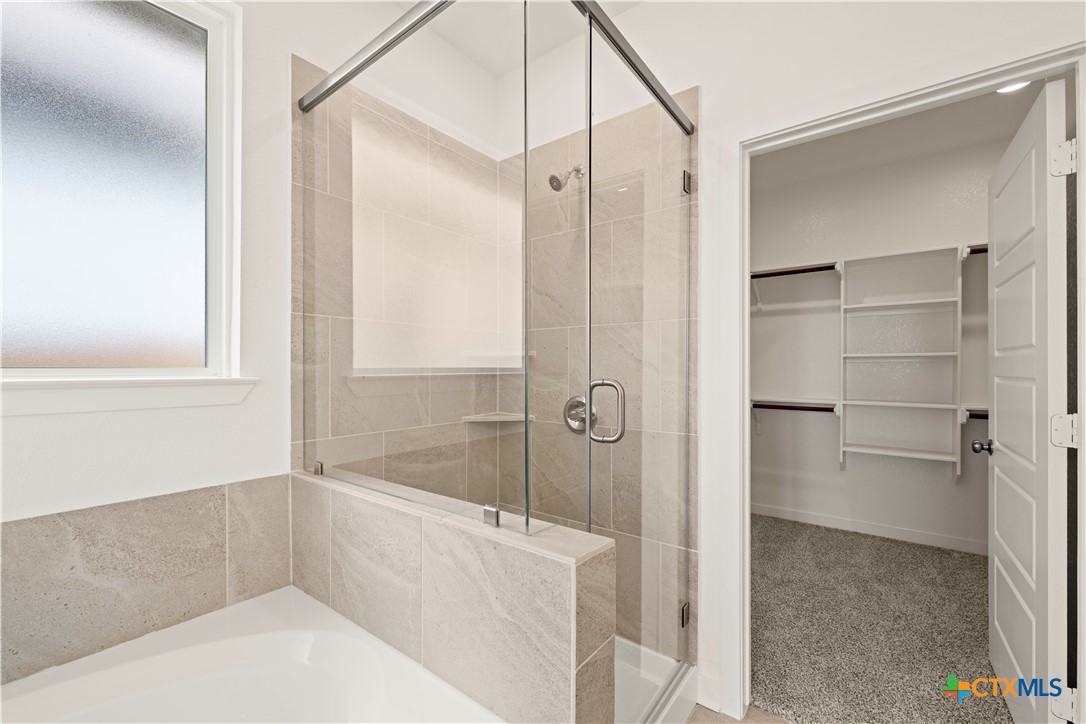7715 Krenek Tap Drive Temple, TX 76502 - Photo 18 of 30 a bathroom with a bathtub and a shower