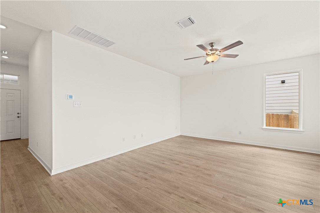 7715 Krenek Tap Drive Temple, TX 76502 - Photo 20 of 30 a view of empty room with wooden floor and ceiling fan