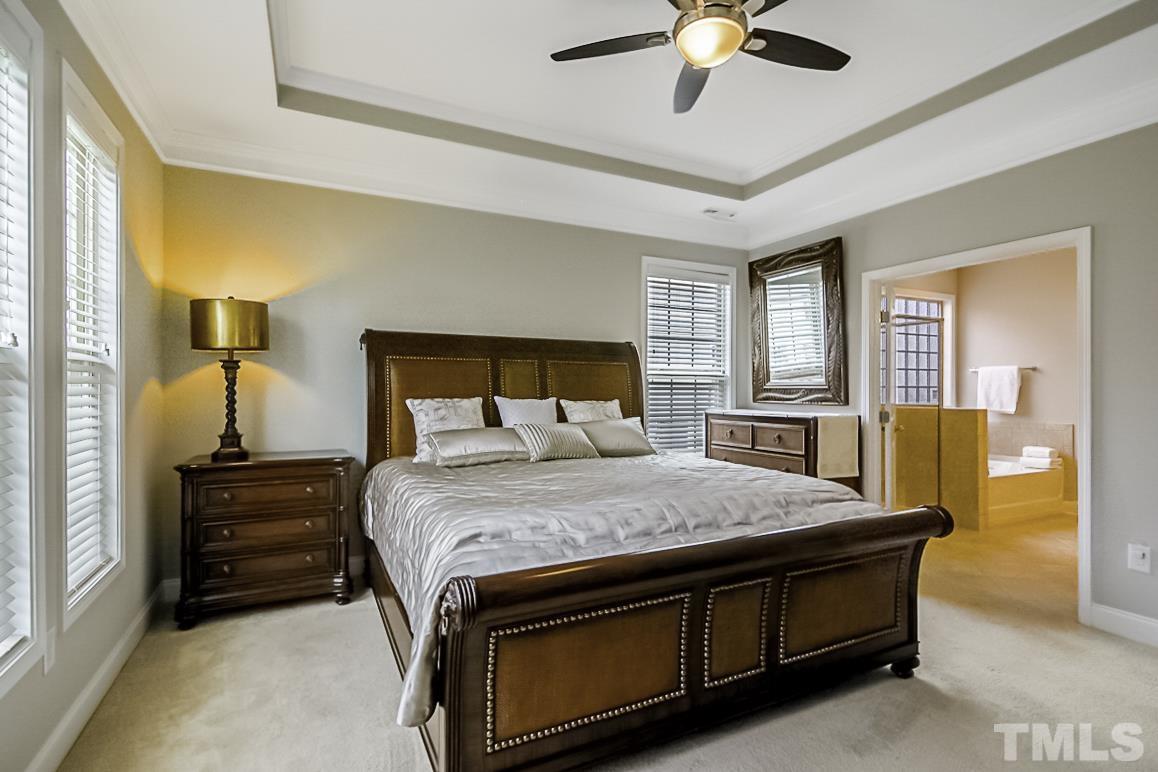 7617 Channery Way Raleigh, NC 27616 - Photo 21 of 42 a bedroom with a bed and a chandelier