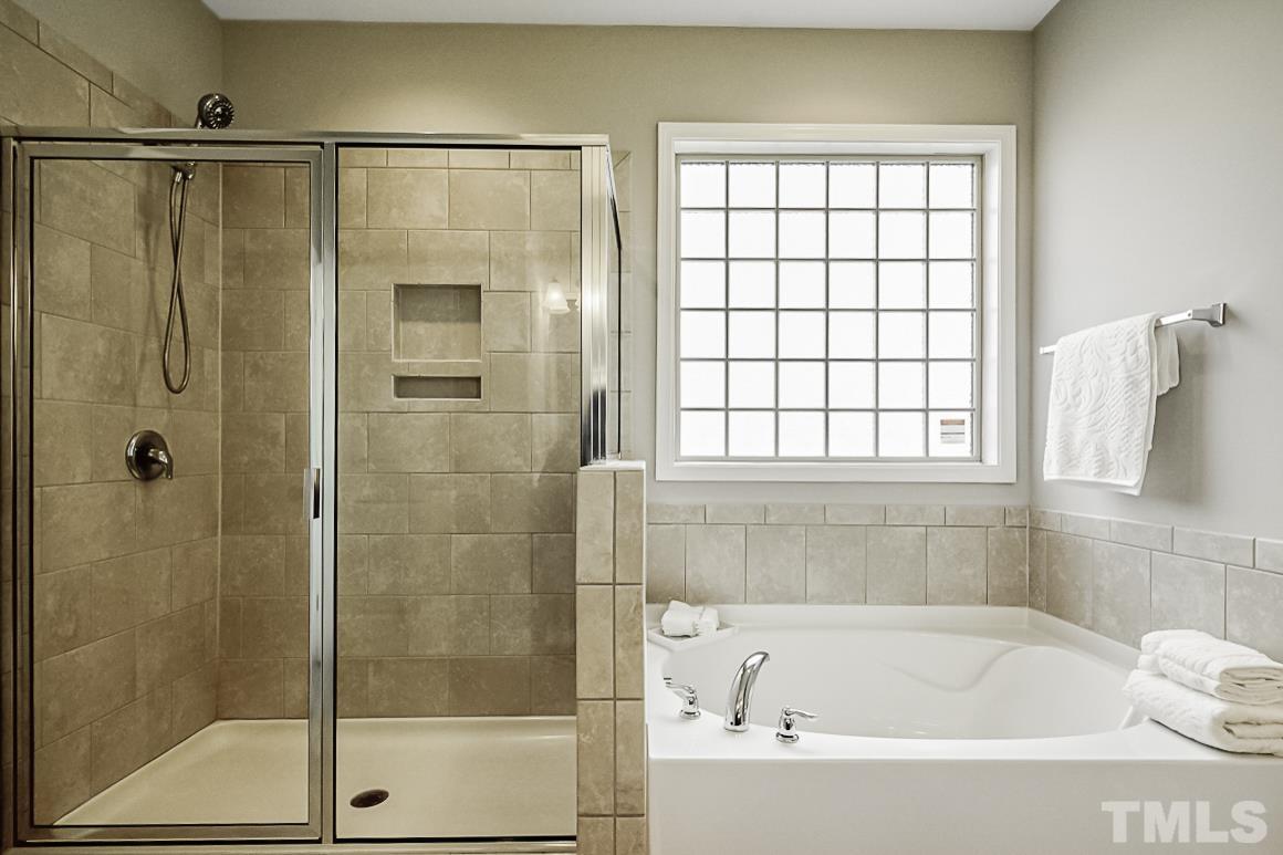 7617 Channery Way Raleigh, NC 27616 - Photo 23 of 42 a bathroom with a bathtub and shower