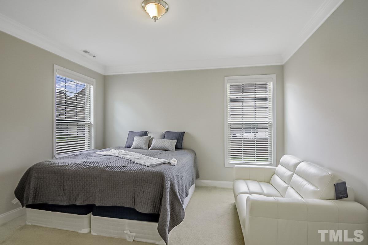 7617 Channery Way Raleigh, NC 27616 - Photo 24 of 42 a bedroom with a bed and a couch