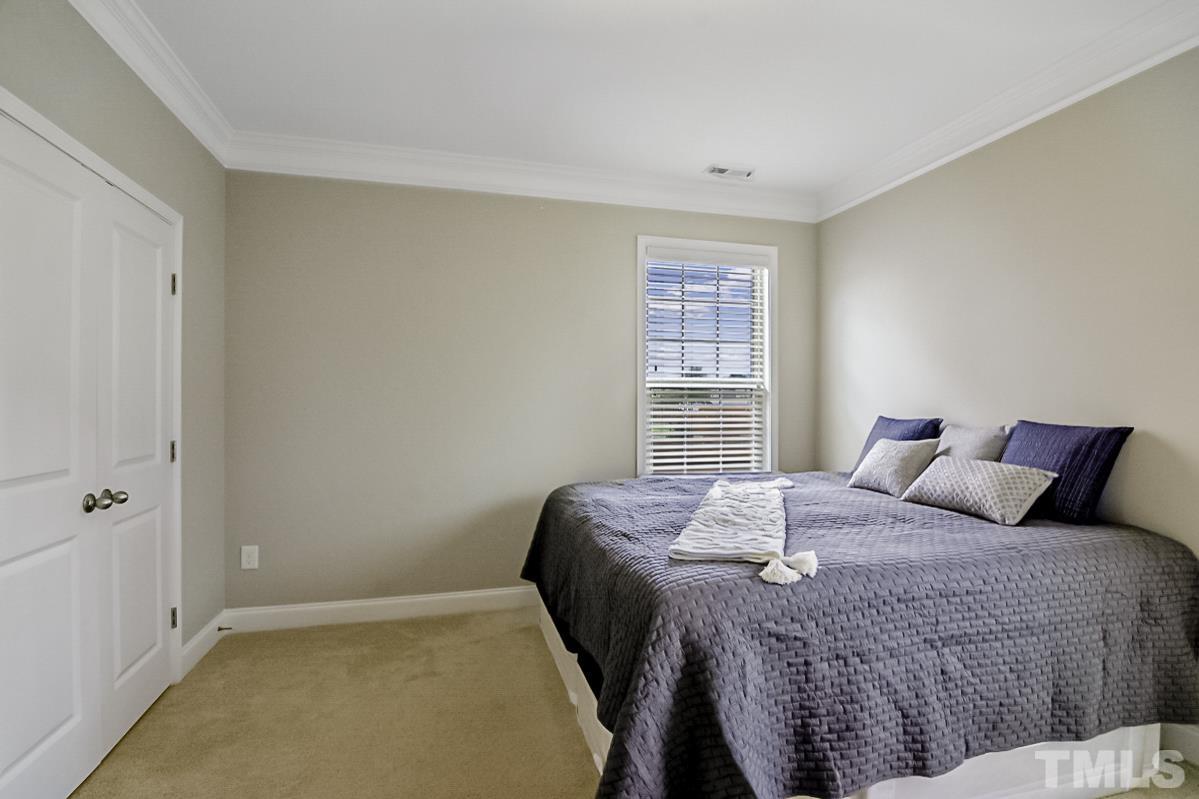7617 Channery Way Raleigh, NC 27616 - Photo 25 of 42 a bedroom with a bed and a window