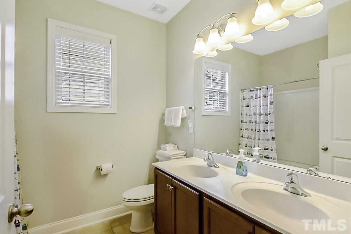 7617 Channery Way Raleigh, NC 27616 - Photo 26 of 42 a bathroom with a double vanity sink toilet and a mirror