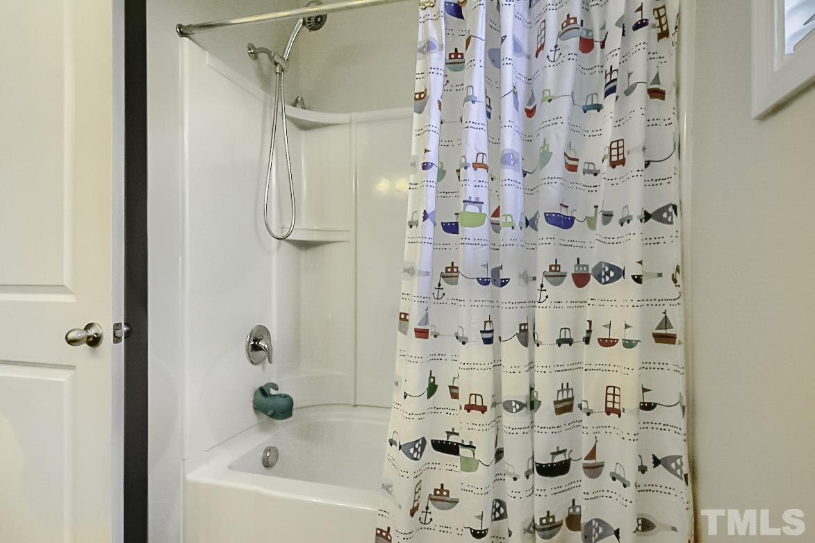 7617 Channery Way Raleigh, NC 27616 - Photo 27 of 42 a bathroom with a bathtub and shower curtain