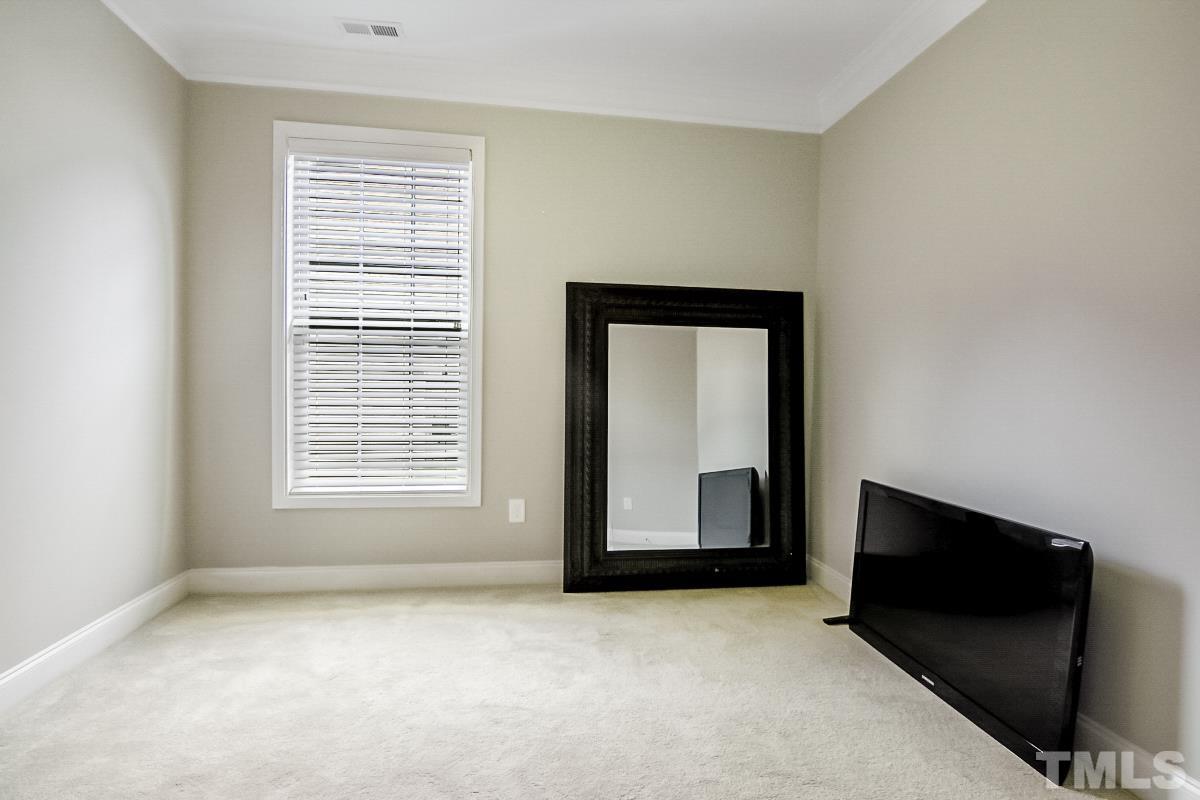 7617 Channery Way Raleigh, NC 27616 - Photo 28 of 42 a view of an empty room with a fireplace and a window