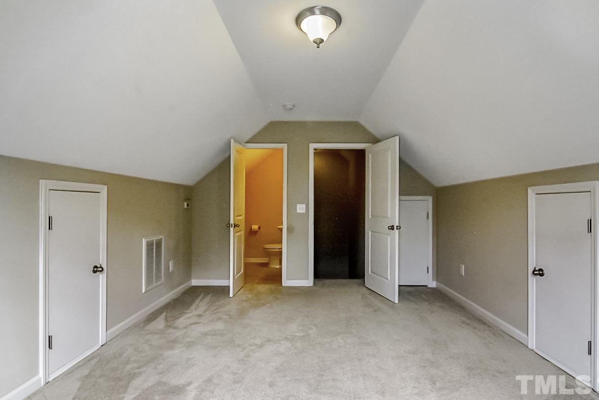 7617 Channery Way Raleigh, NC 27616 - Photo 31 of 42 an empty room with closet and mirror