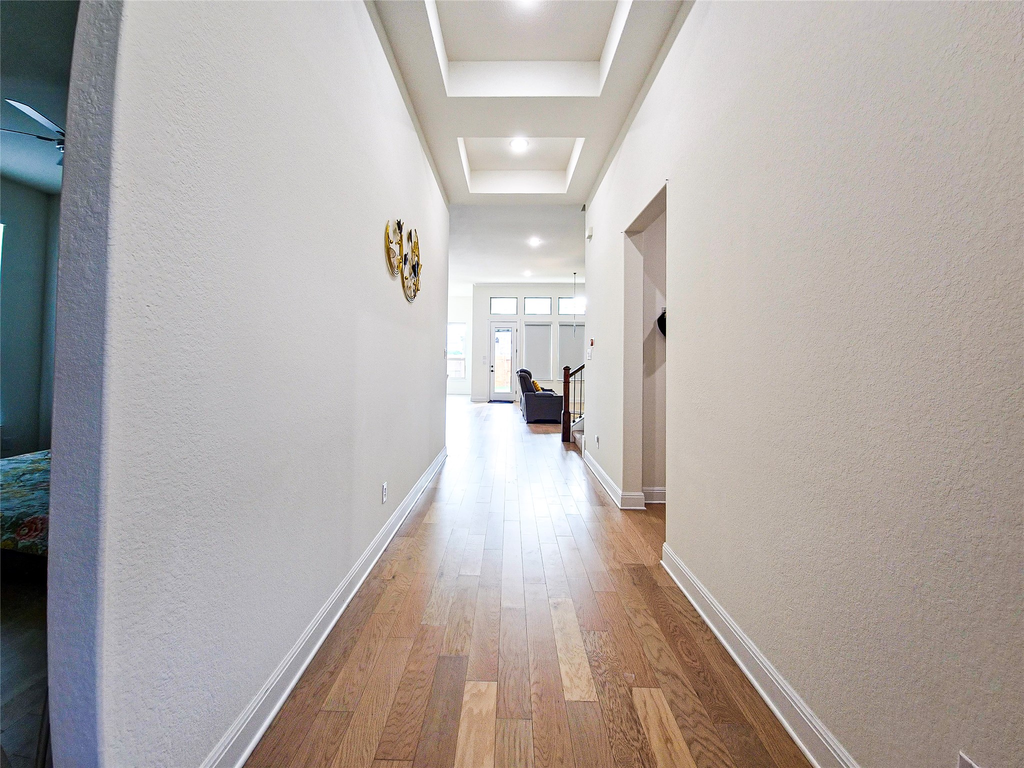 813 Sunny Ridge Drive Leander, TX 78641 - Photo 3 of 32 A long entryway boasts warm hardwood floors and recessed lighting.