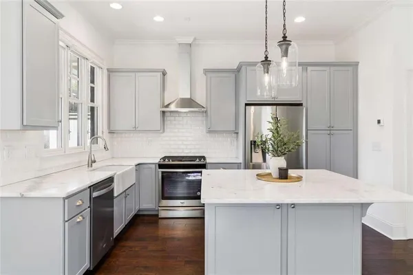 a kitchen with a sink a stove and cabinets