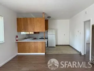 a kitchen with granite countertop a refrigerator and a stove