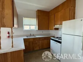a kitchen with a sink a stove and refrigerator