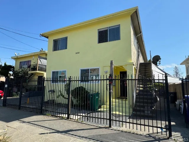 a view of a house with iron fence