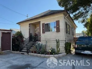 a front view of a house with cars parked