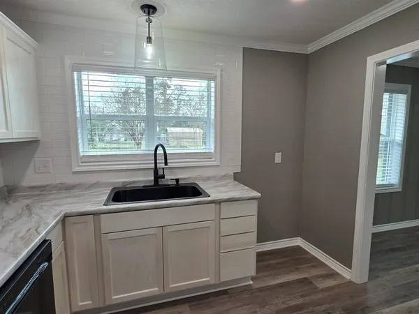 a kitchen with sink and window