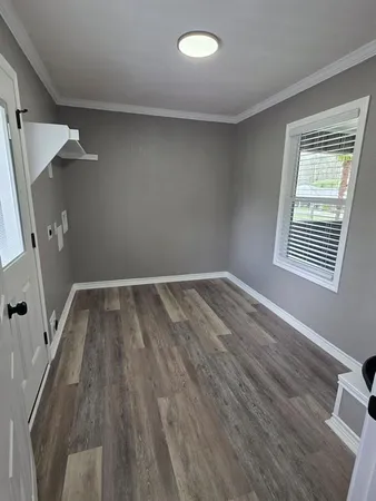 wooden floor in an empty room with a window