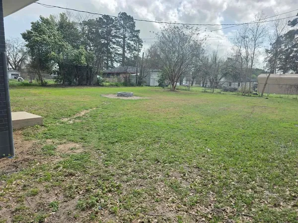 a view of a field with trees in the background