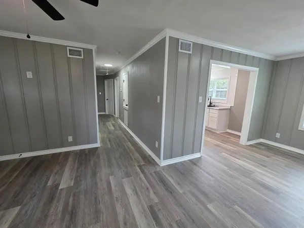 a view of a hallway with wooden floor