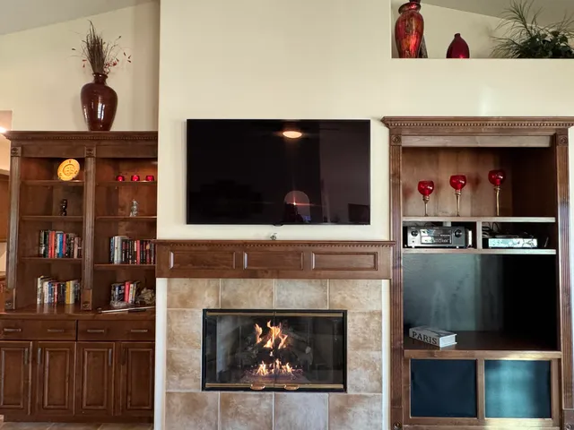 a bedroom with furniture and a flat screen tv