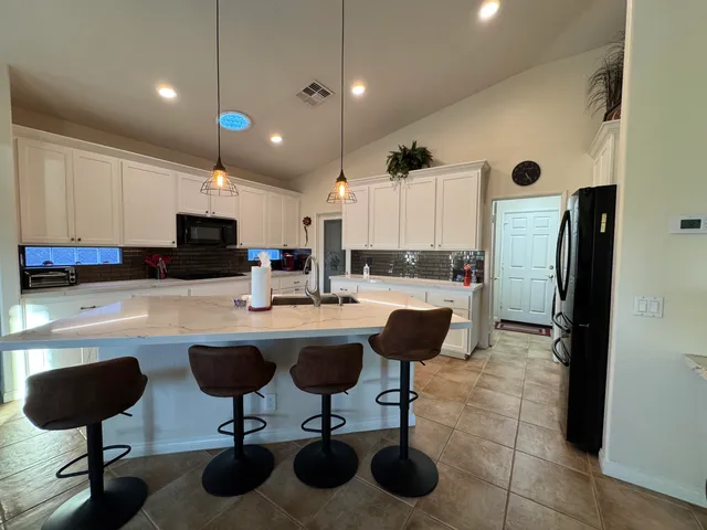 a view of a kitchen with furniture and a window