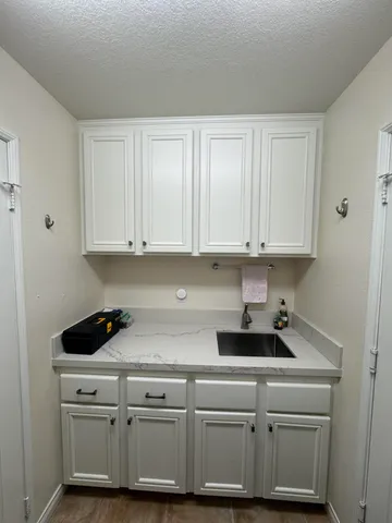 a bedroom with a bed couch and dresser