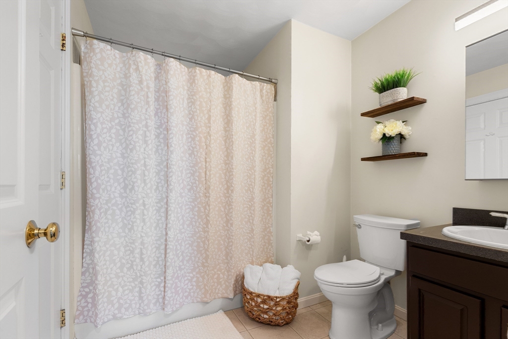 2 Ricciuti Drive, Unit 9 Quincy, MA 02169 - Photo 25 of 40 a bathroom with a toilet a sink and a shower